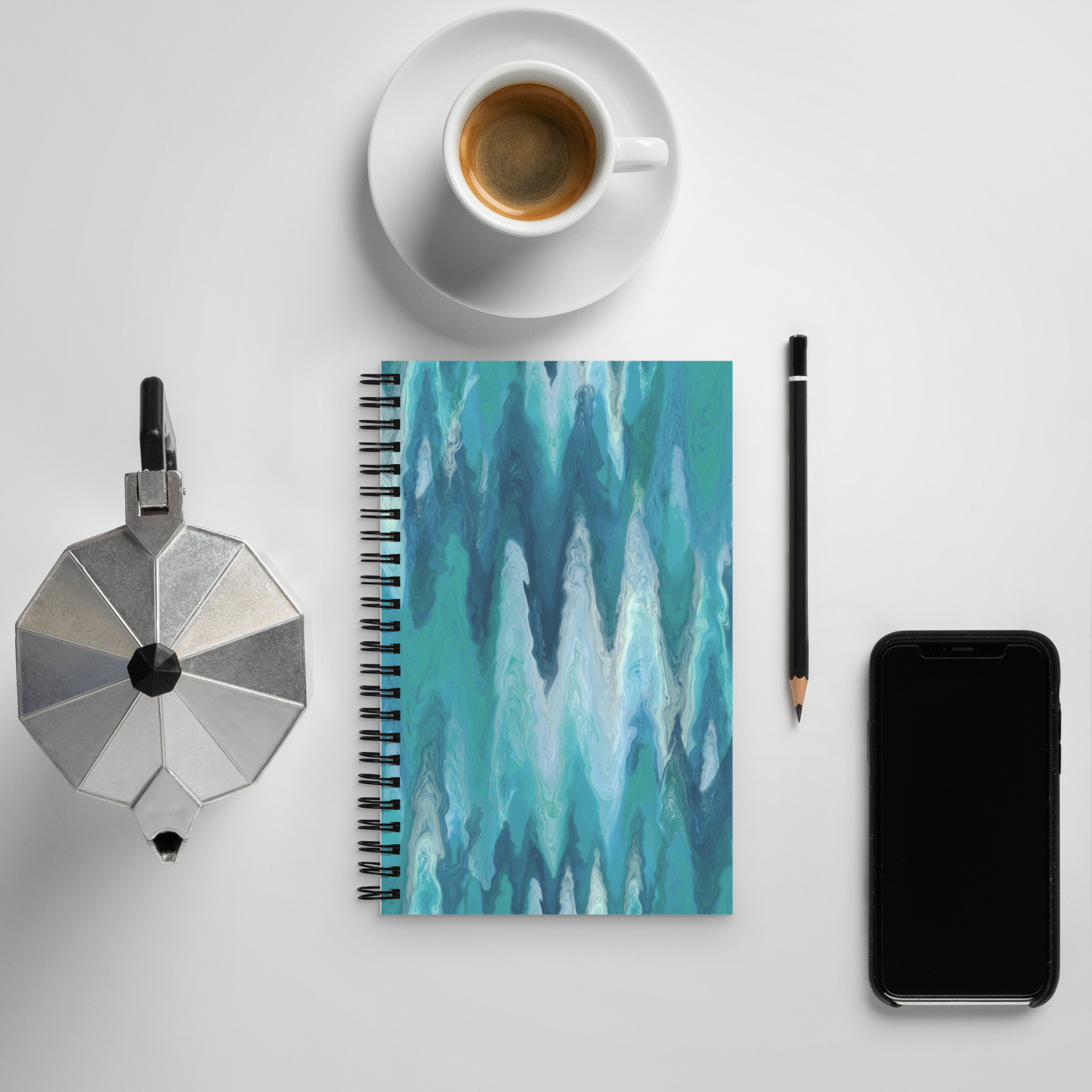 Blue and green soft colors marbled in elegant pattern atop a spiral bound notebook.